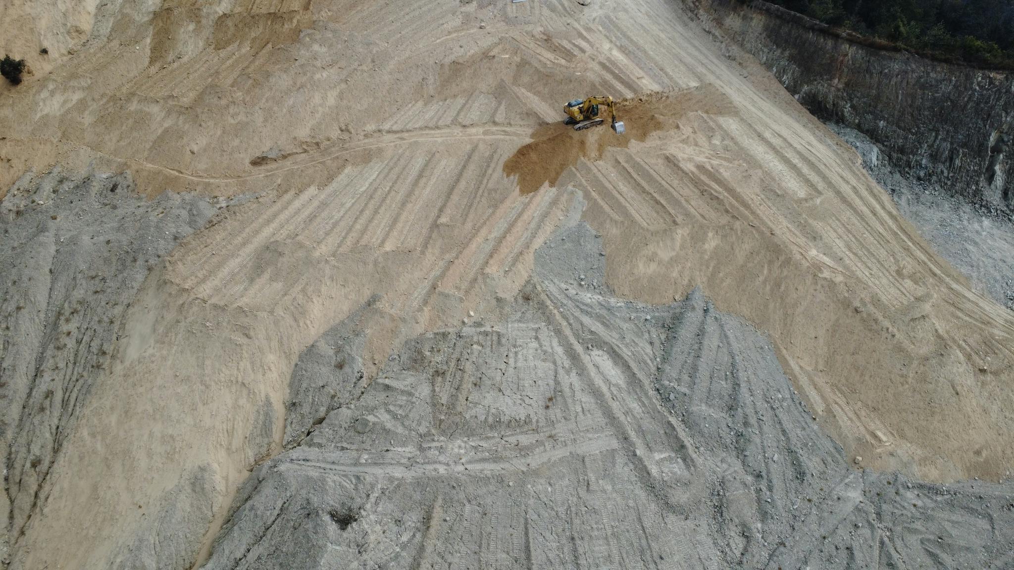 Drone view of a construction site with excavator in Panauti, Nepal.